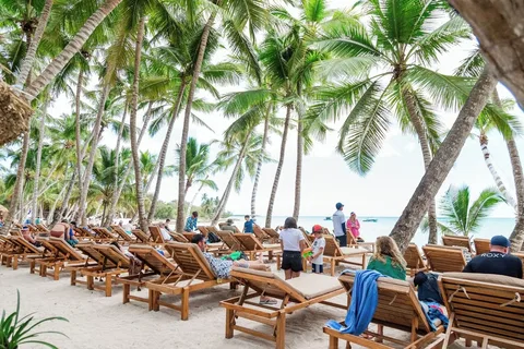 Saona Island beach lounge area with palm trees