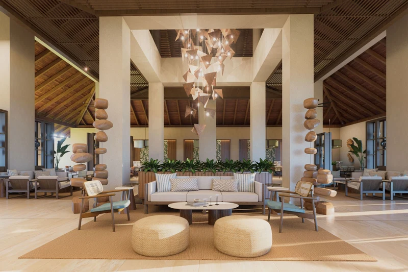 A spacious lobby with a central seating area, large windows, and a modern chandelier.