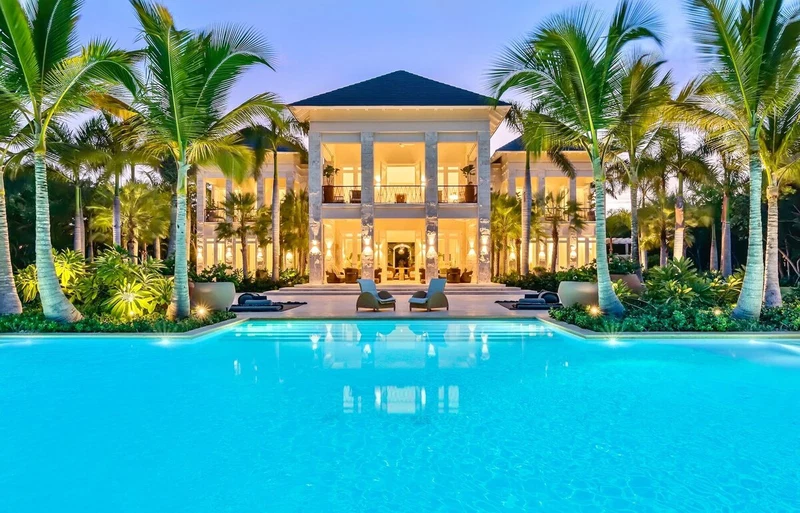 A large, two-story building with a swimming pool in front.