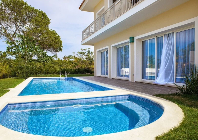 A two-story building with a swimming pool.