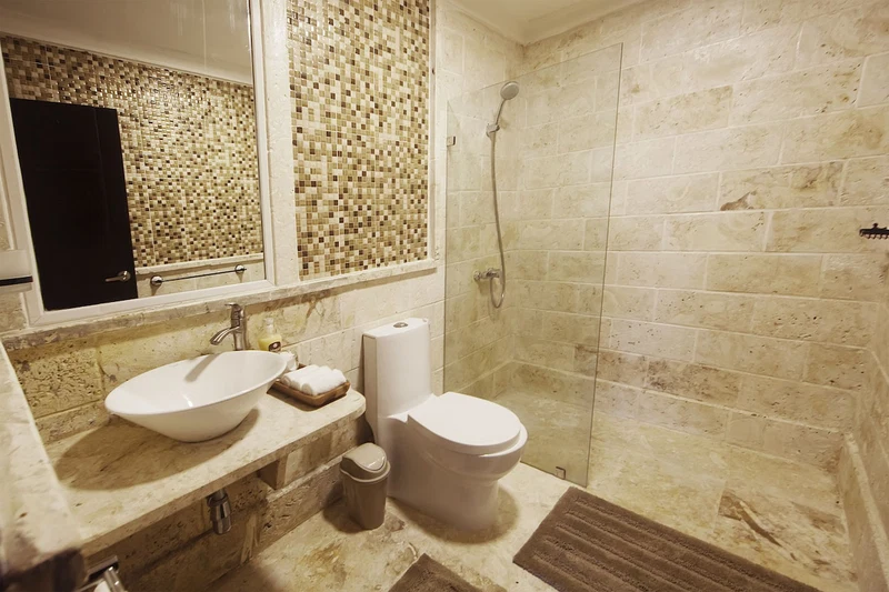 A bathroom with a sink, toilet, and shower.